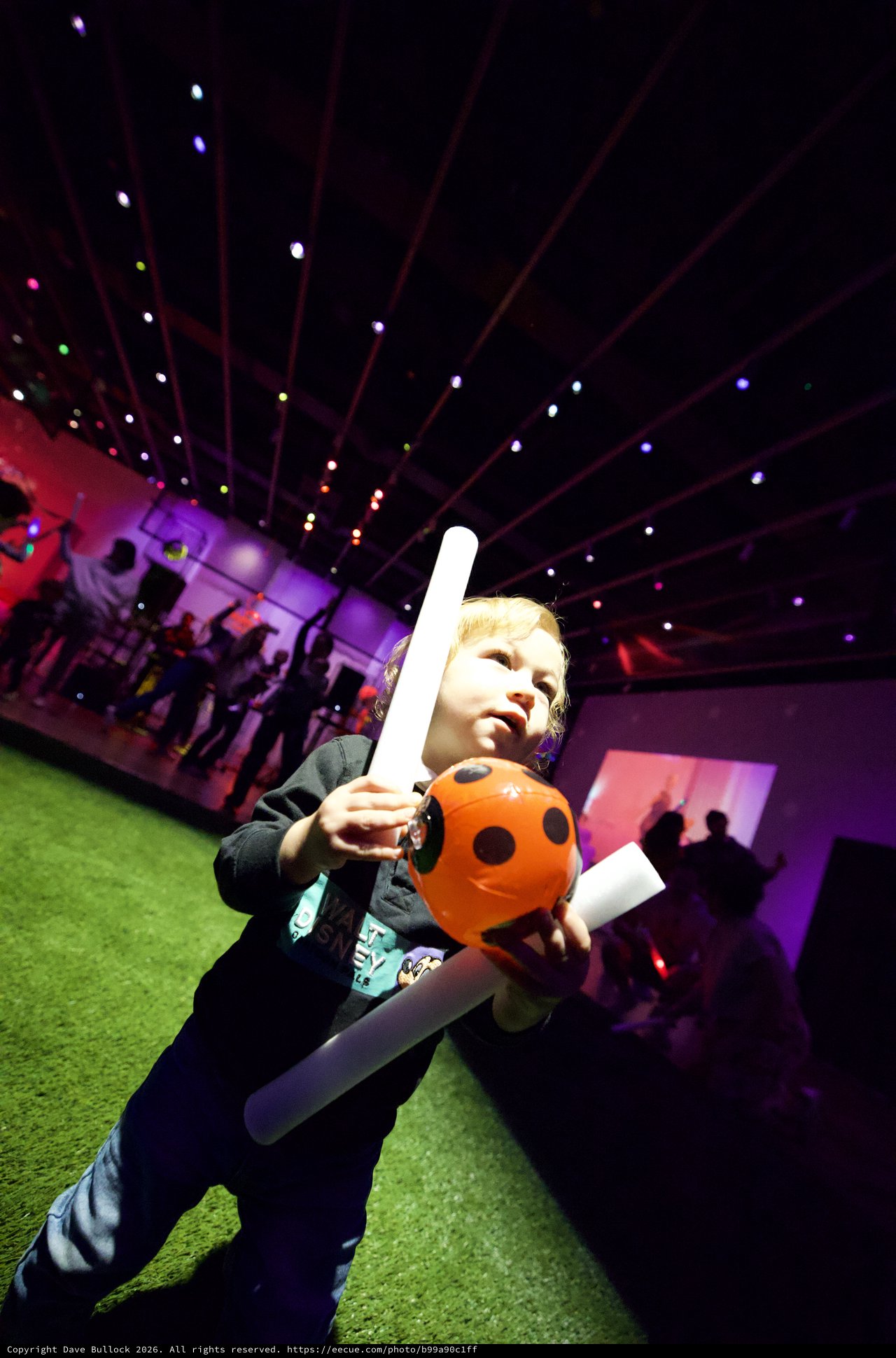 Young Child Enjoying Halloween-Themed Baby Rave with Light Sword
