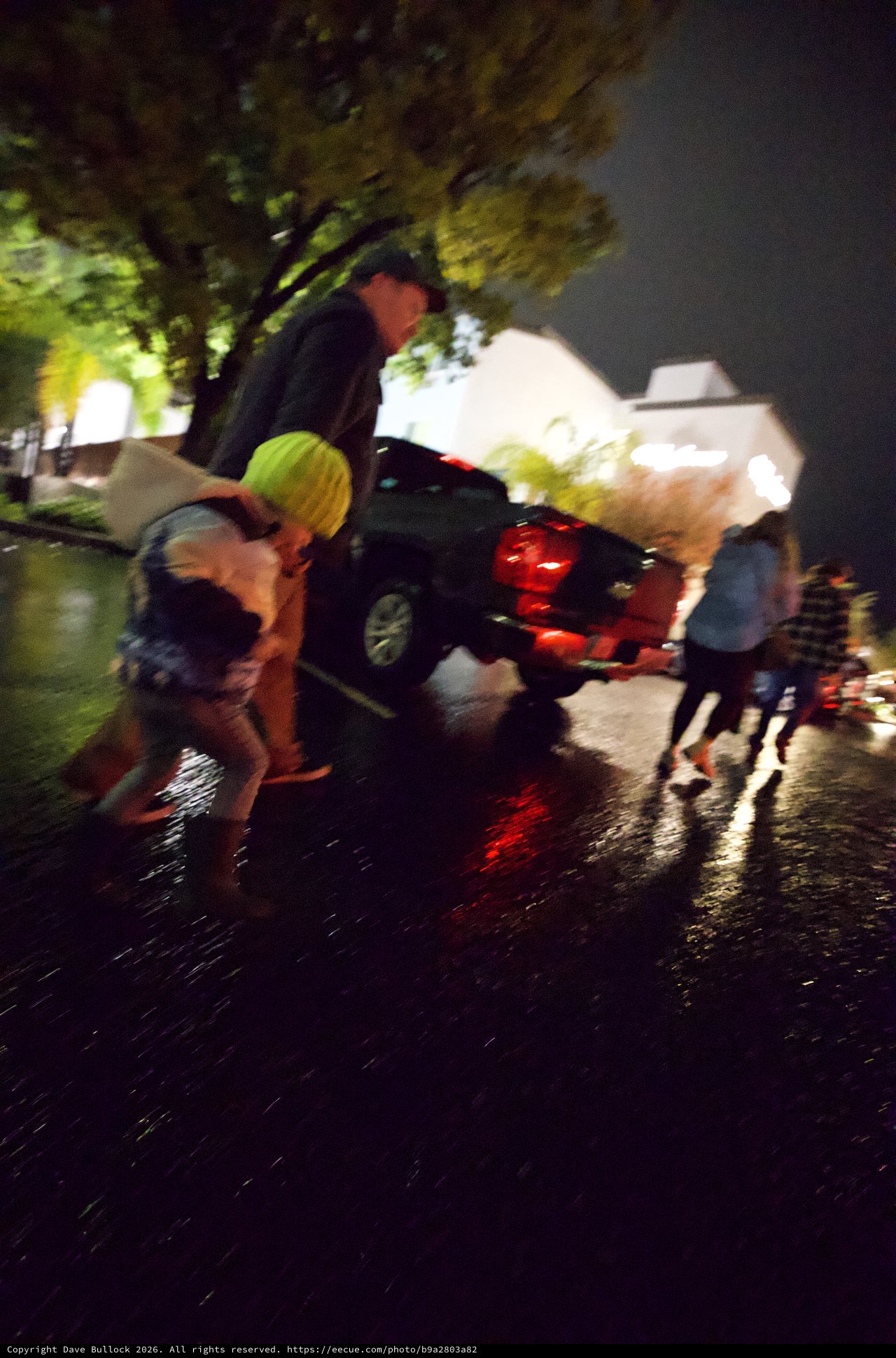 Nighttime Emergency Scene with Wet Streets and Responders