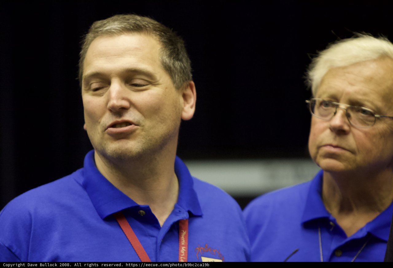 Two Men in Blue Shirts Talk Post-Interview