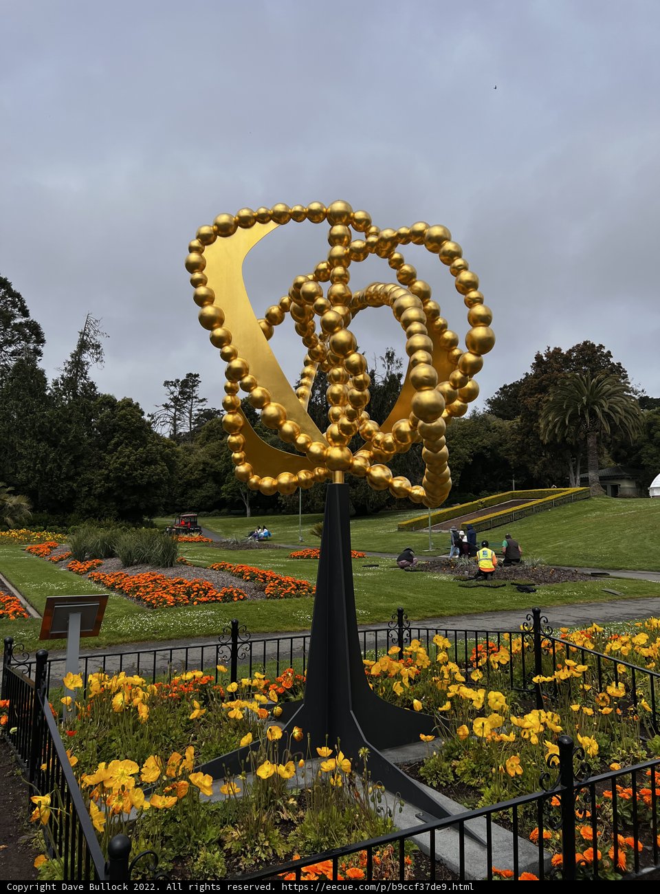 Golden Park Statue with Blooming Beauty
