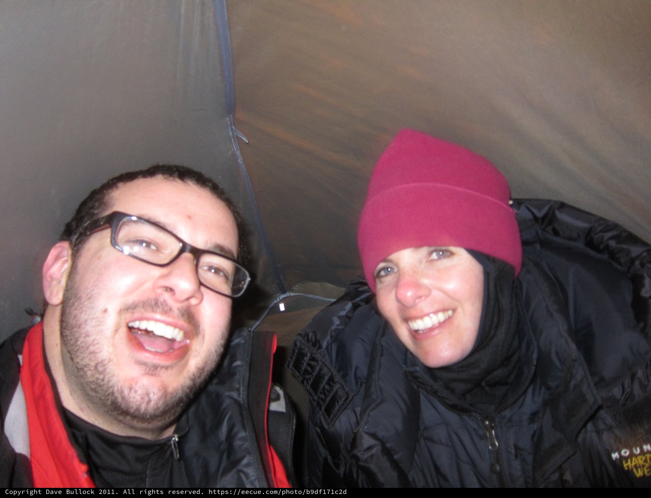 Two Friends Laughing Together Inside a Camping Tent