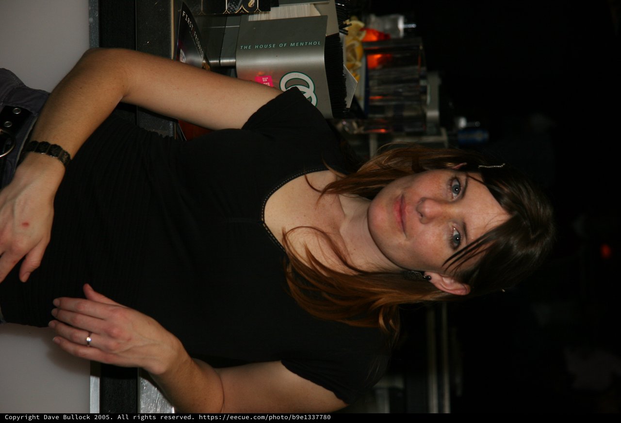 Bartender Penelope Poses Behind the Bar