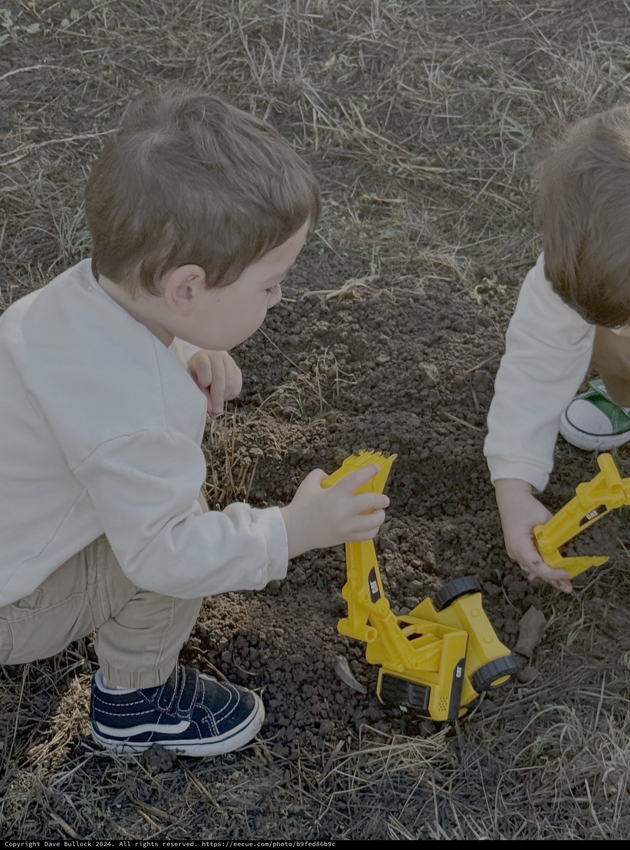 Children Playing with Yellow Toy Trucks Outdoors