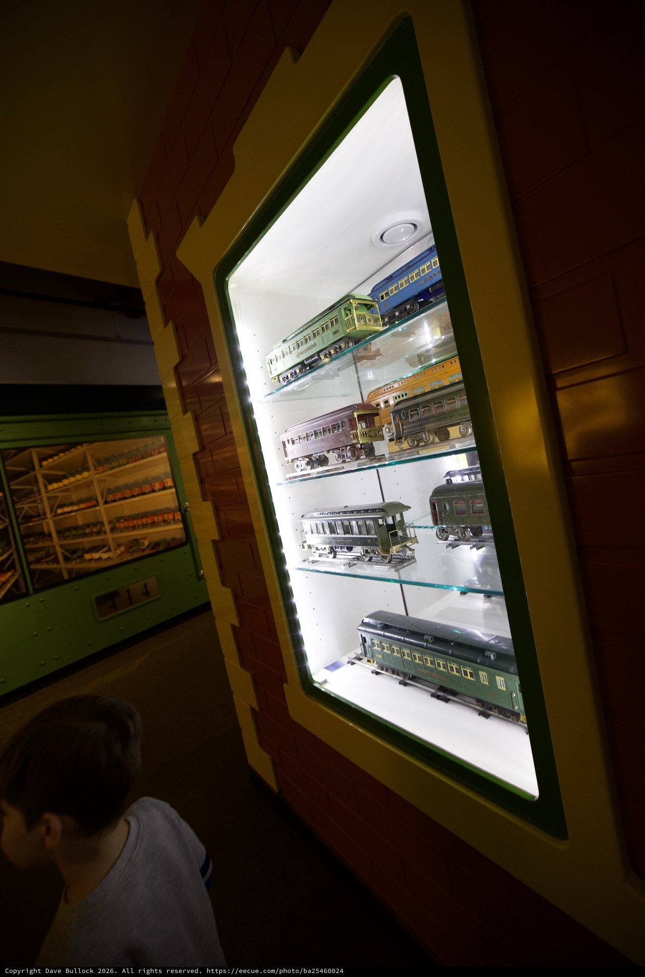 Child Observing Vintage Model Train Display in Museum