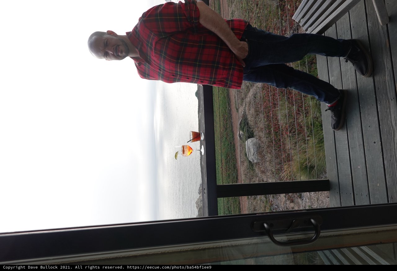 Man Enjoying Coastal Drinks at Scenic Overlook