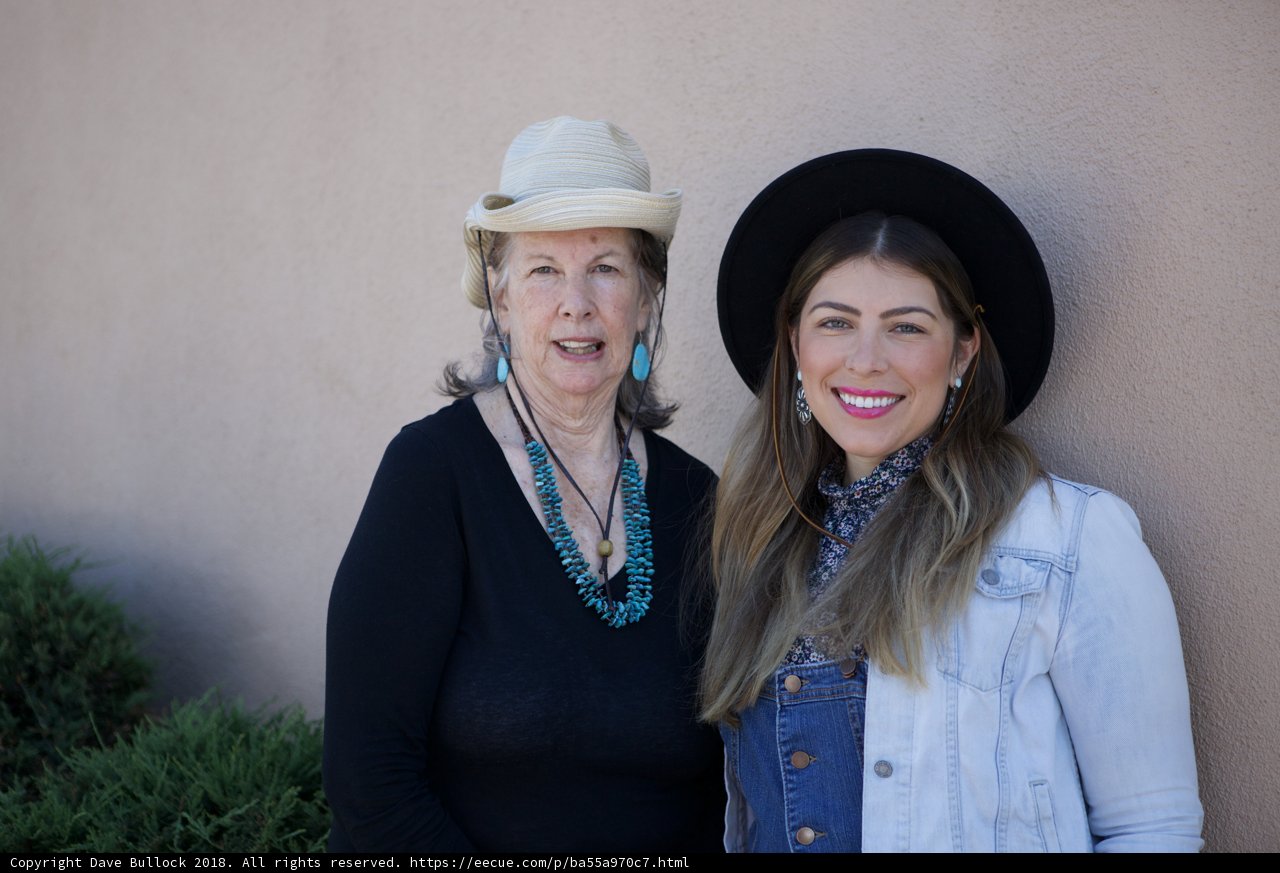 Two Women Rocking Hats and Smiling