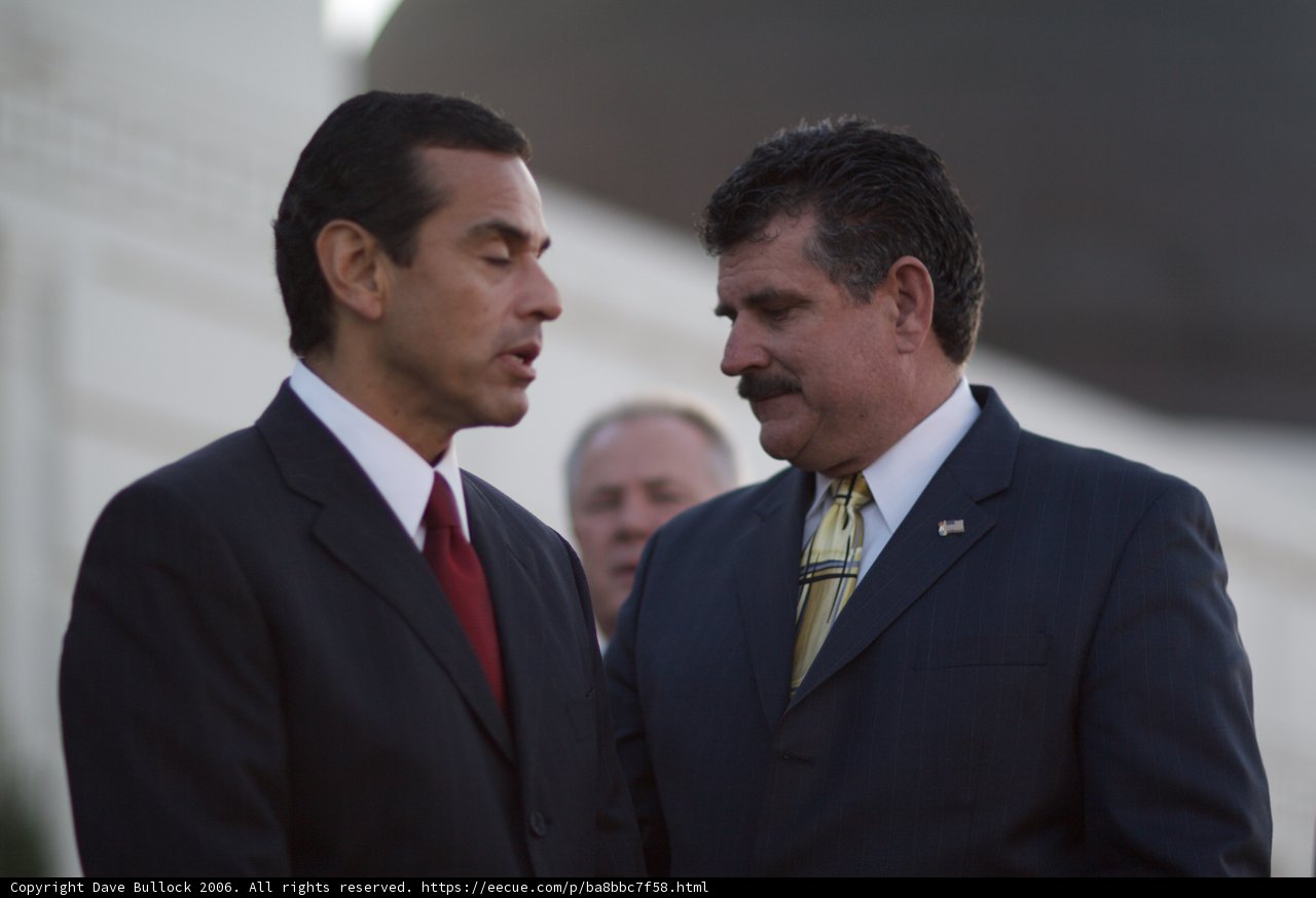 Two Men in Suits Stand Beside Antonio Villaraigosa