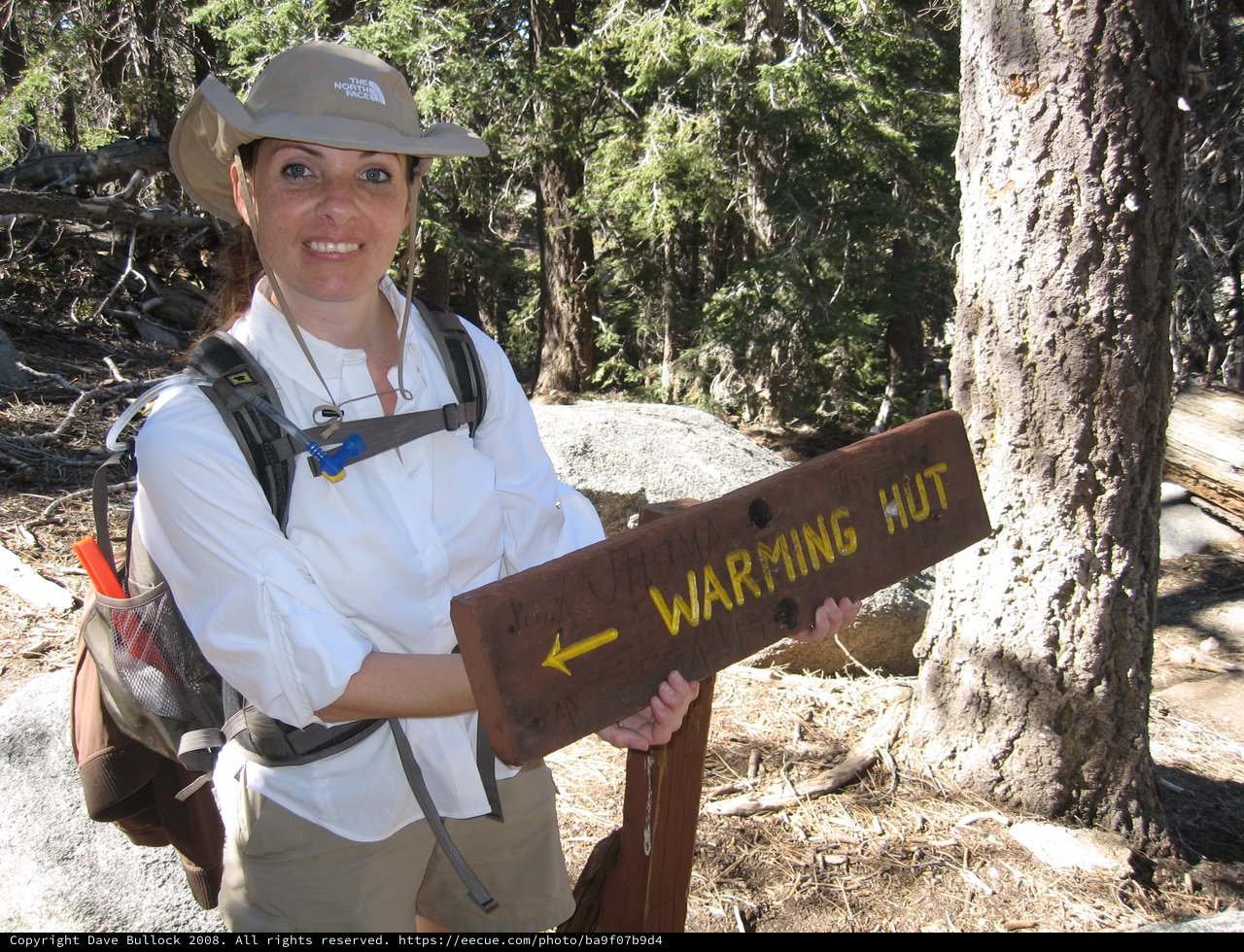 Hiker Posing at Warming Hut Trail Sign