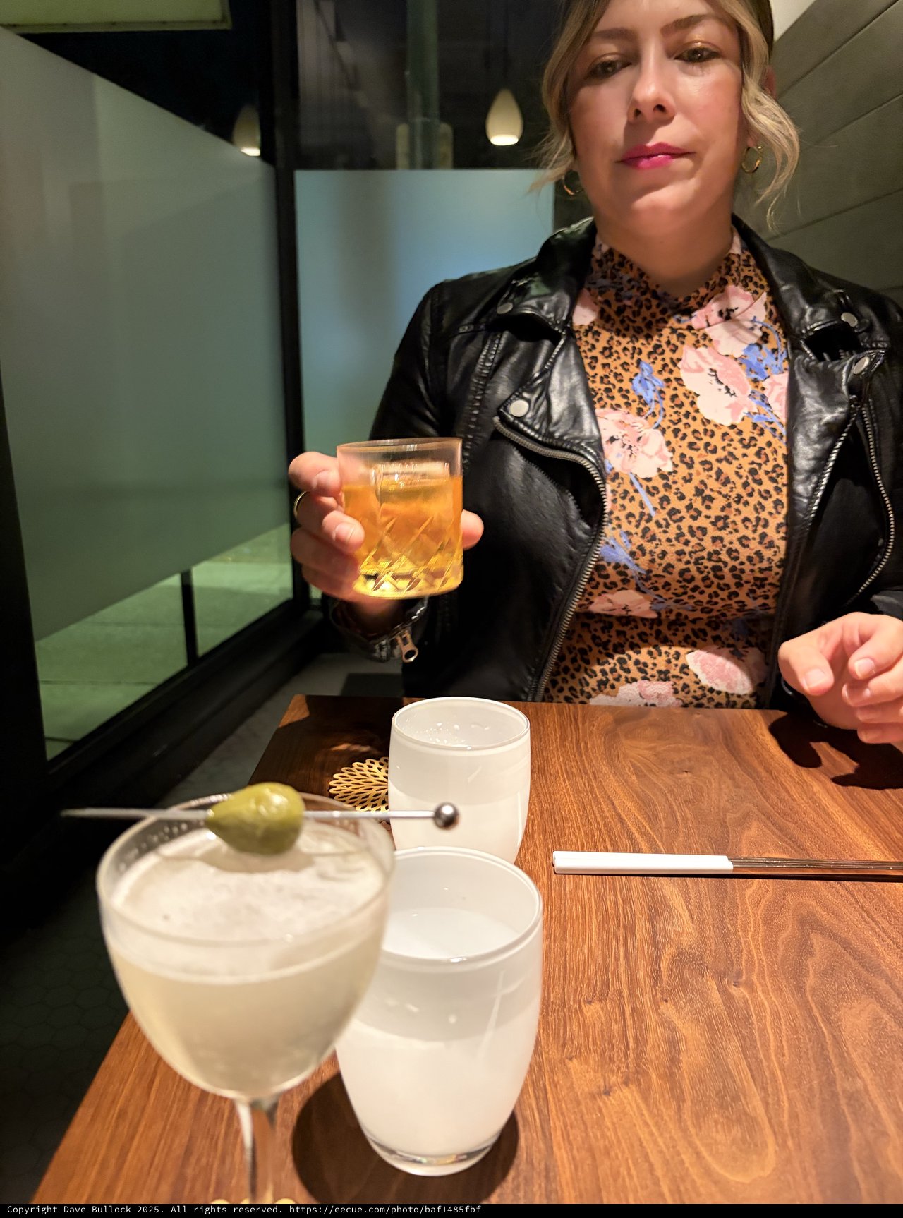 Woman Enjoying Cocktails at Modern Restaurant Table