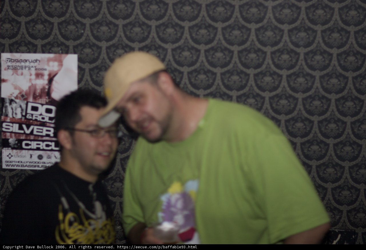 Two Men Sporting Hats and T-Shirts