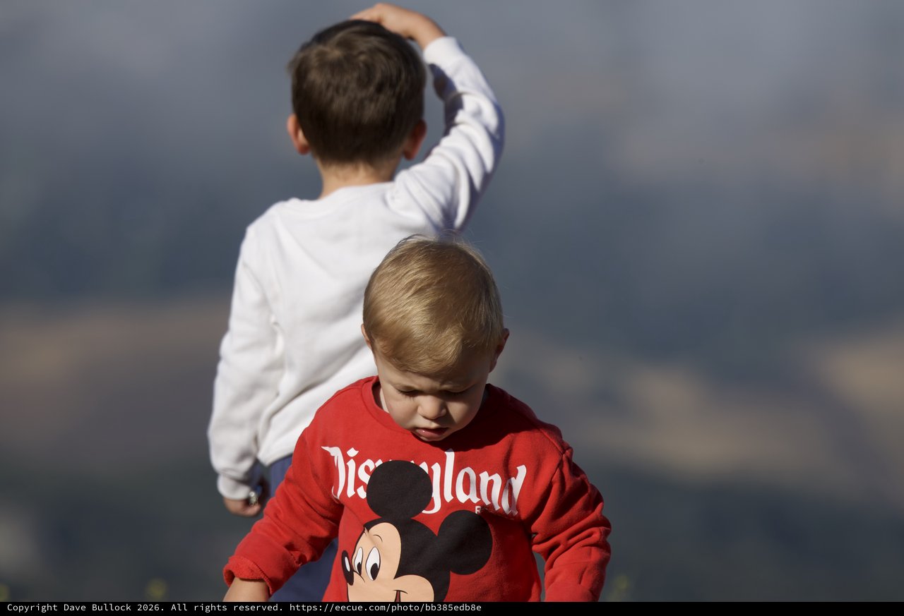 Two Young Boys Exploring Under Stormy Skies