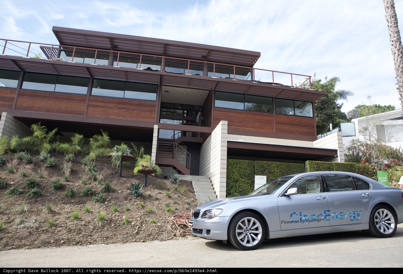 Parked Coupe in Front of Blue Sky House