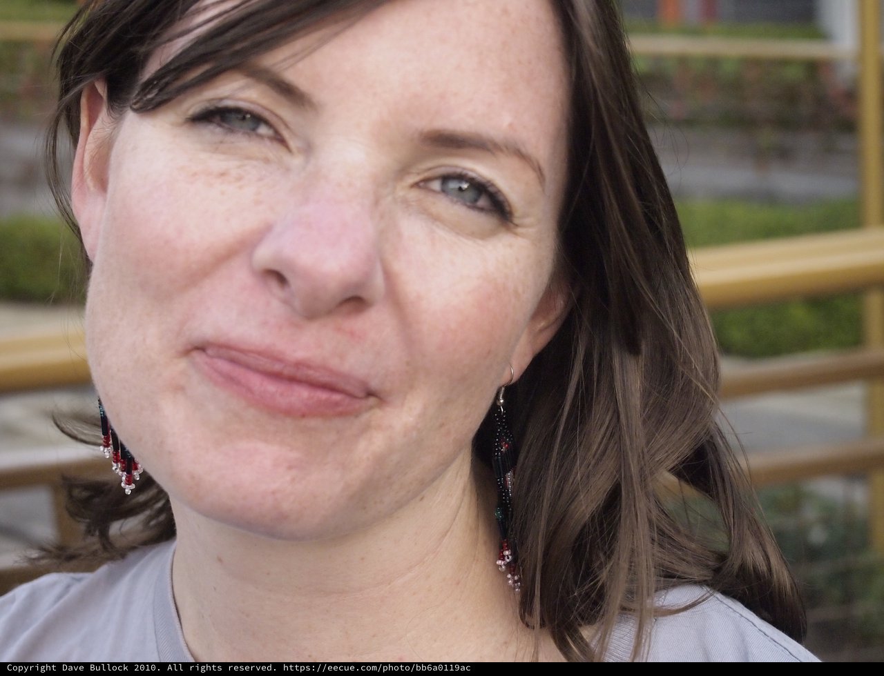 Candid Portrait of Penelope with Beaded Earrings Outdoors