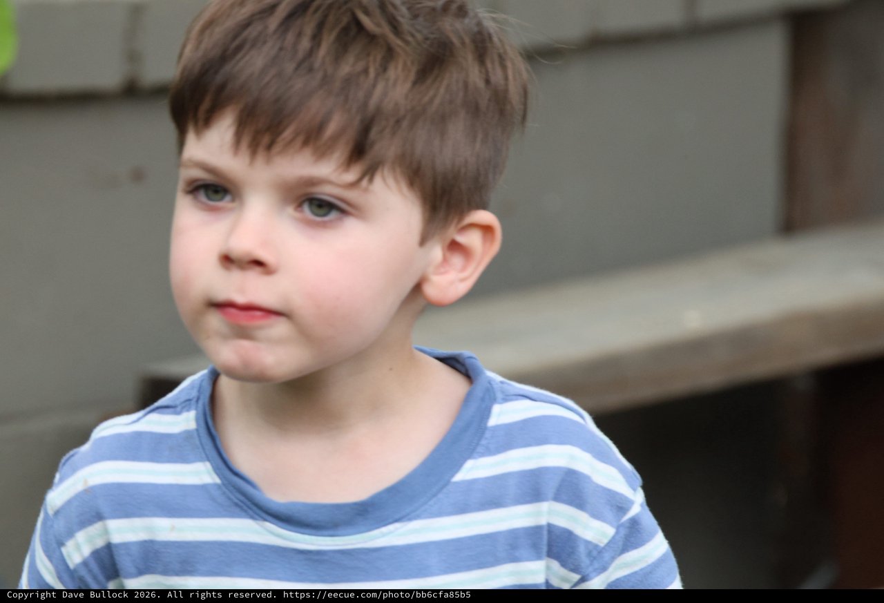 Thoughtful Young Boy in Striped Shirt
