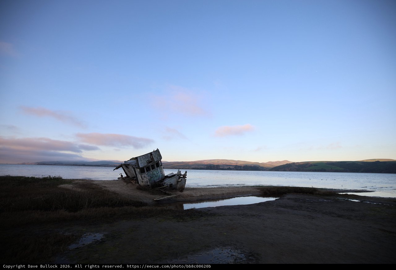 Abandoned Shipwreck at Twilight on Coastal Shore