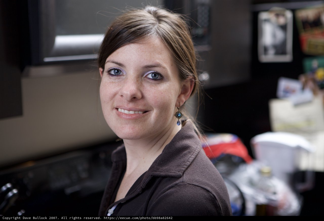 Smiling Woman with Blue Eyes in Office Setting