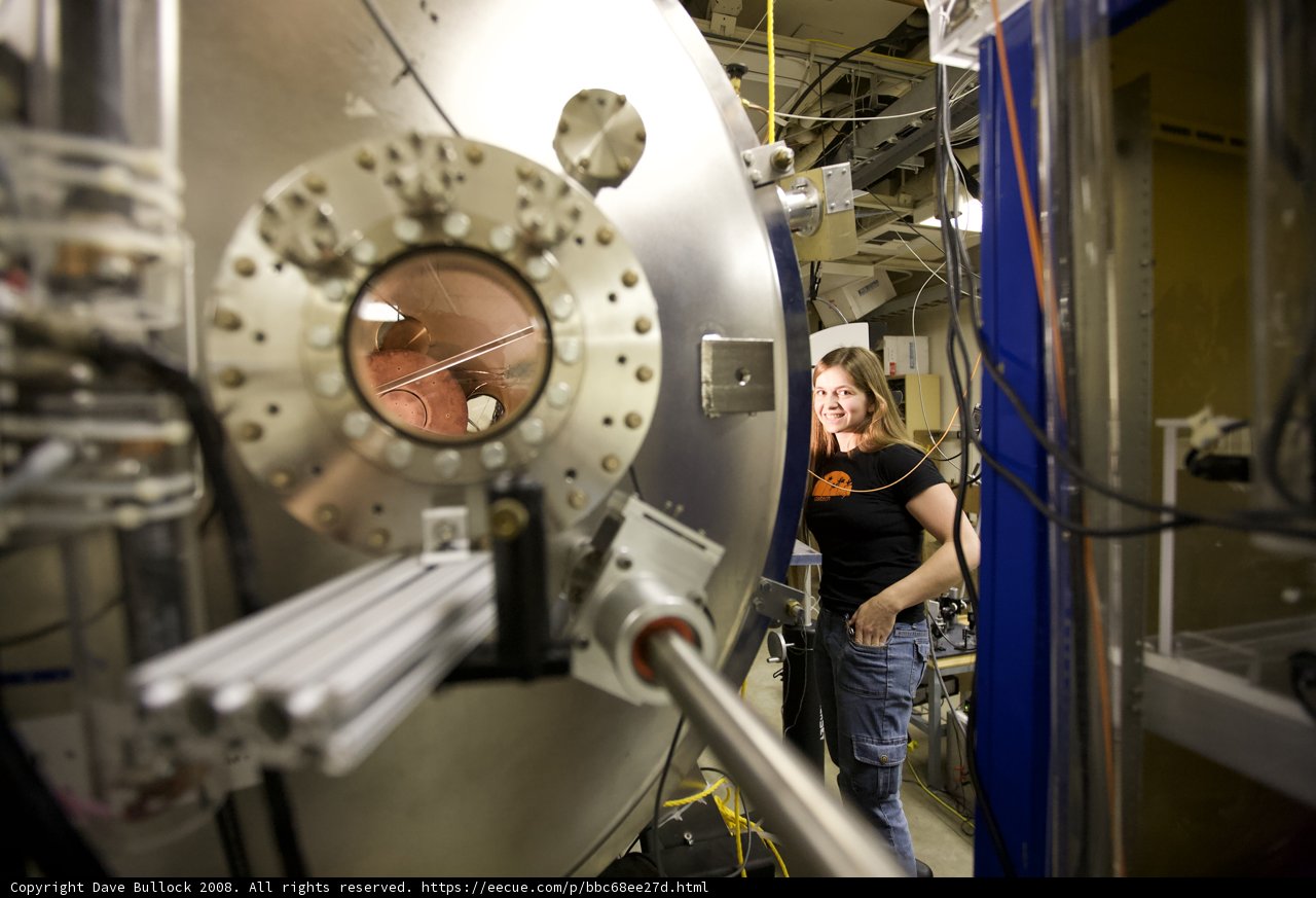 Woman operating large machine in manufacturing factory