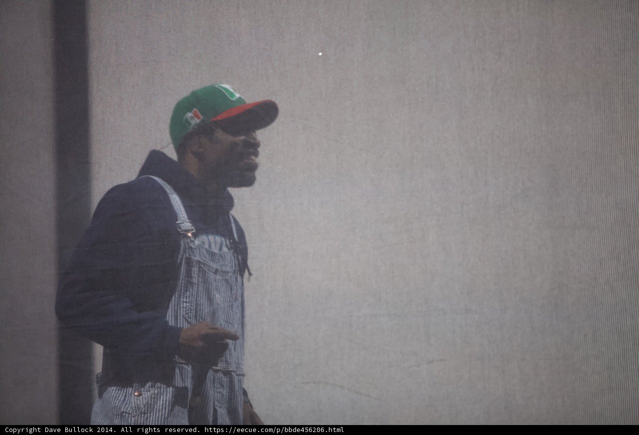 Man in Overalls and Baseball Cap