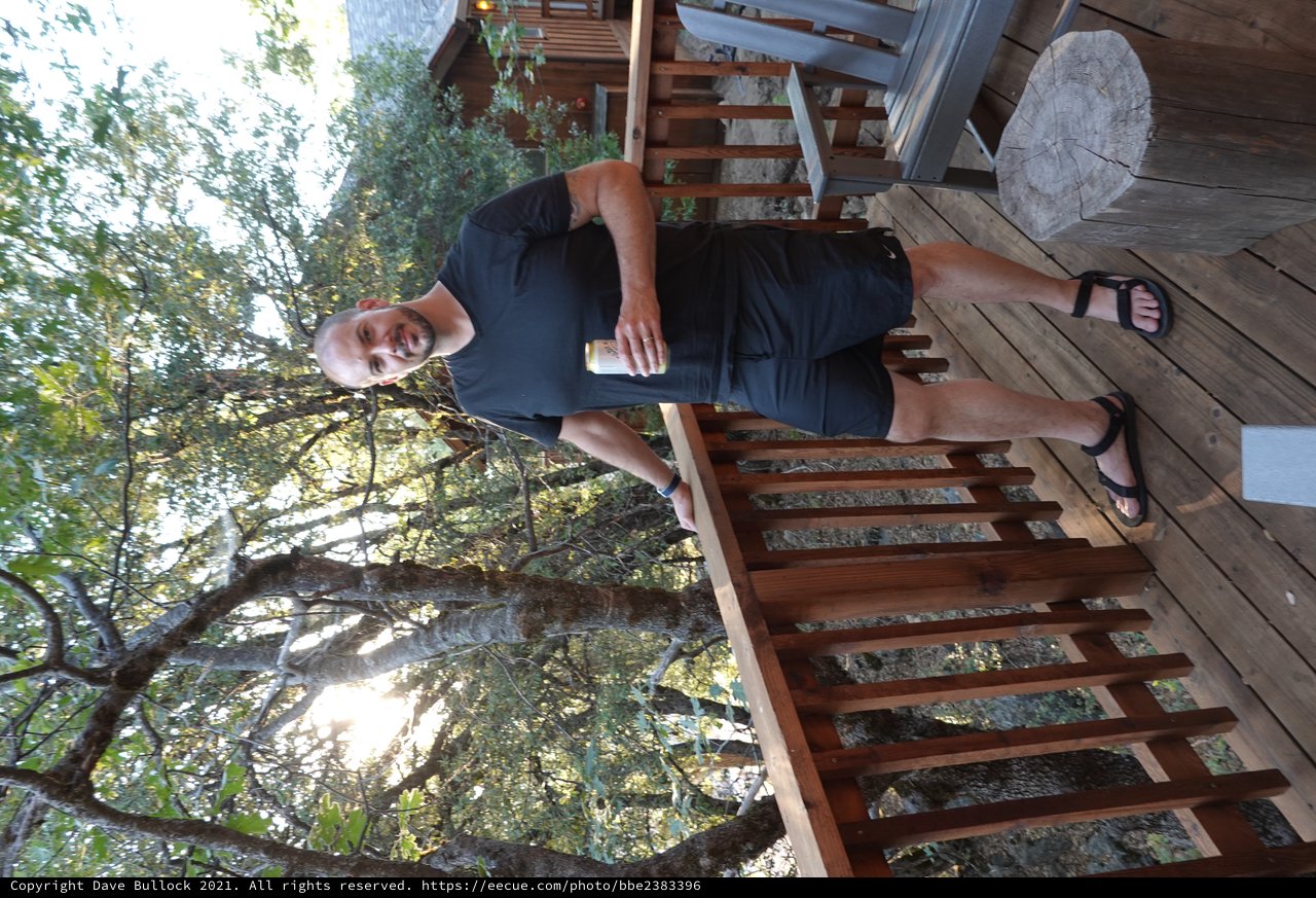 Man Relaxing on Wooded Deck with Drink