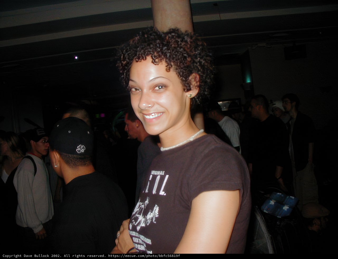 Curly-Haired Beauty in the Nightclub Crowd