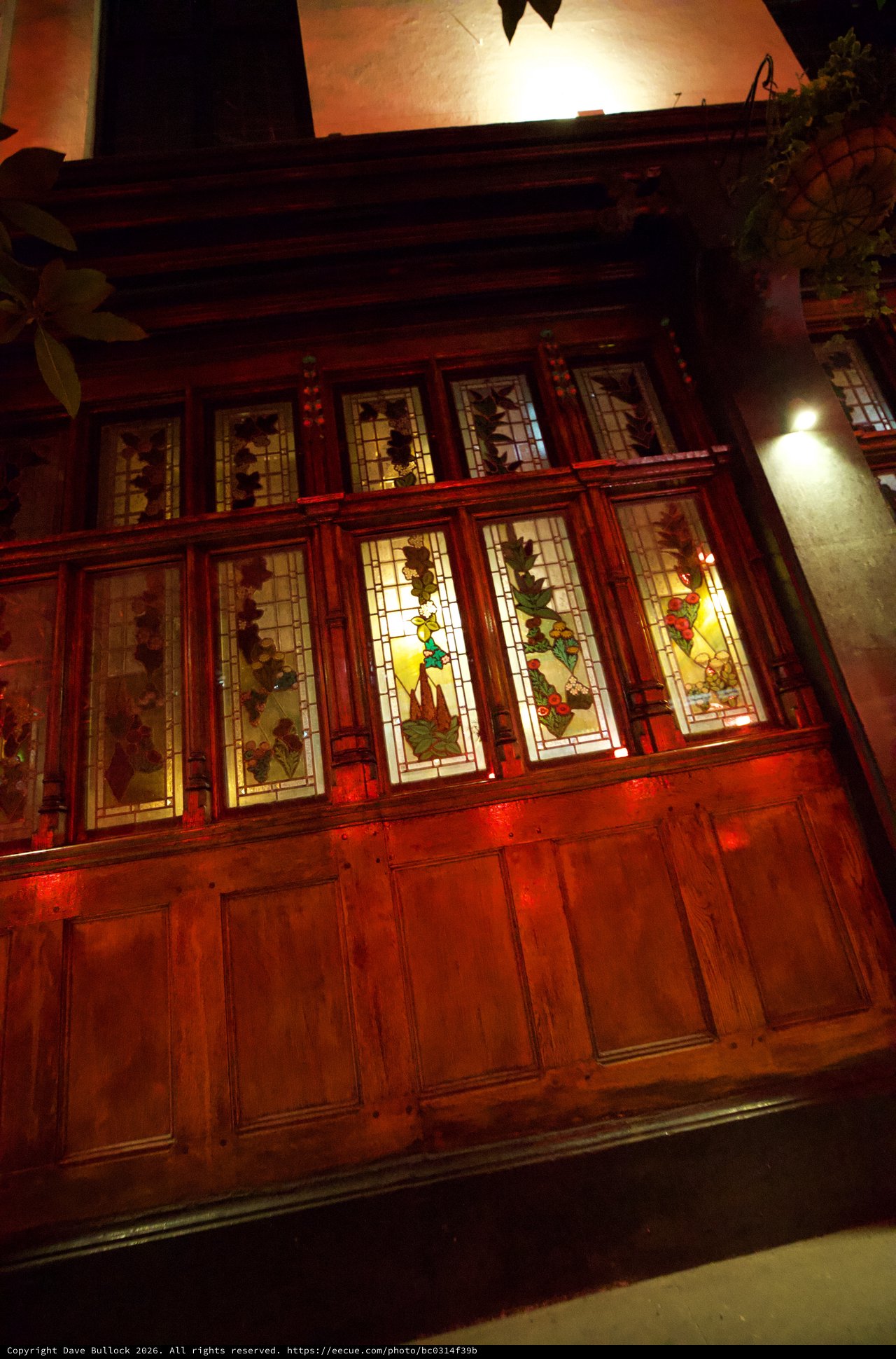 Traditional Chinese Building with Illuminated Stained Glass Windows at Night