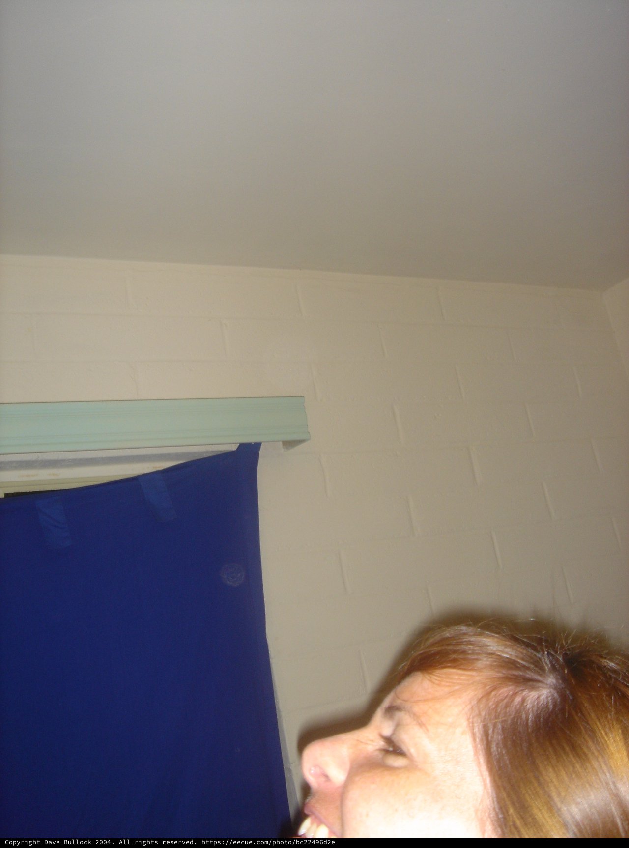 Woman Laughing Upward in Indoor Setting