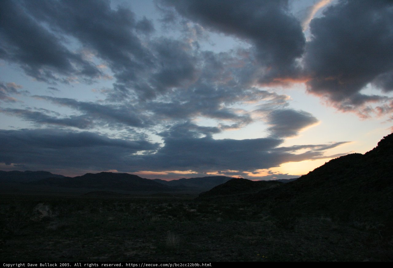 Mountain Silhouette Against Cloudy Sky