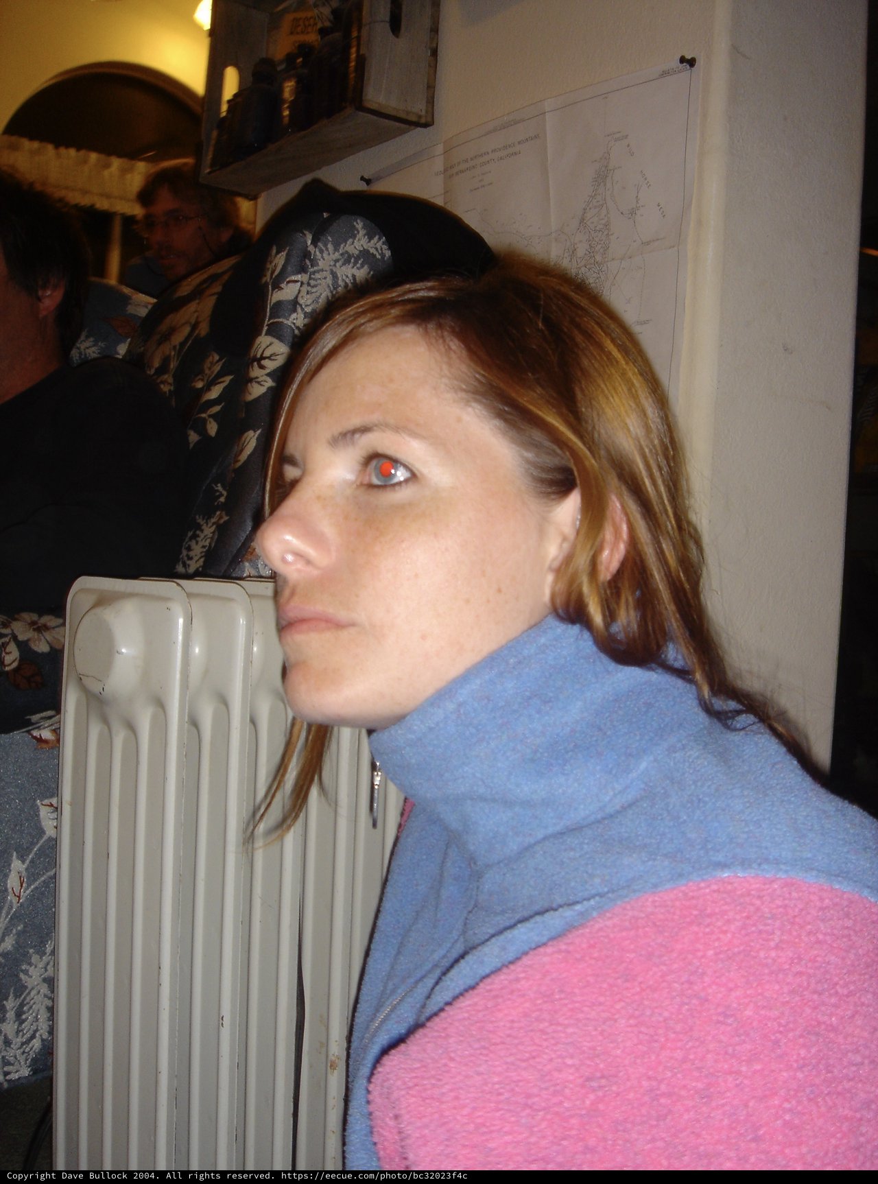 Woman Resting Head on Radiator in Cozy Indoor Setting