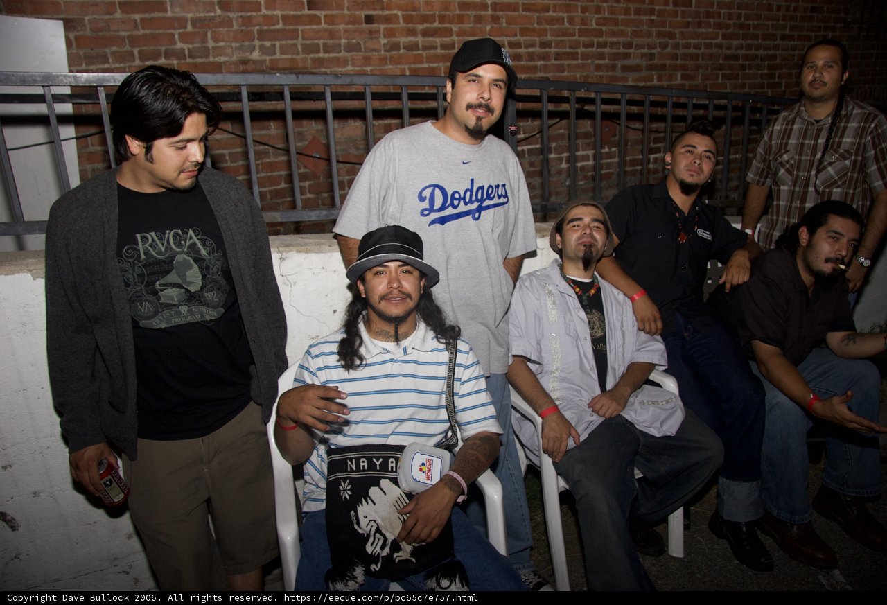 A Group of Men Strike a Pose by the Fence