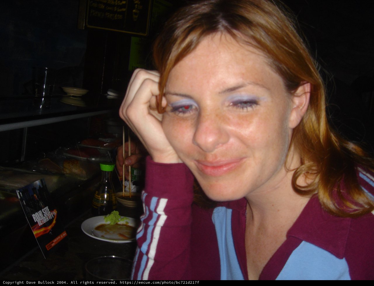 Woman Relaxing at Sushi Restaurant with Smirk