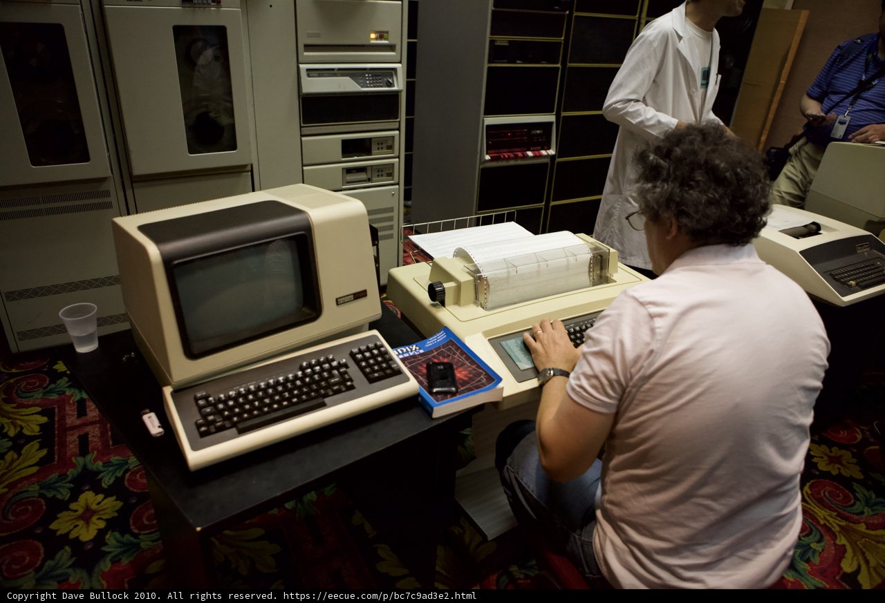 Man at Desk with Computer and Typewriter