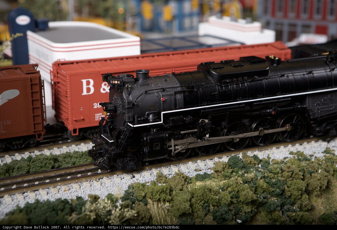 Black Train Engine and Red Train on the Railroad