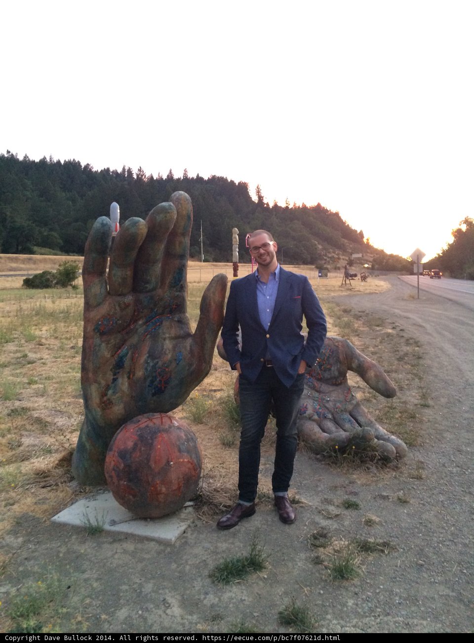 The Man and the Giant Hand Sculpture