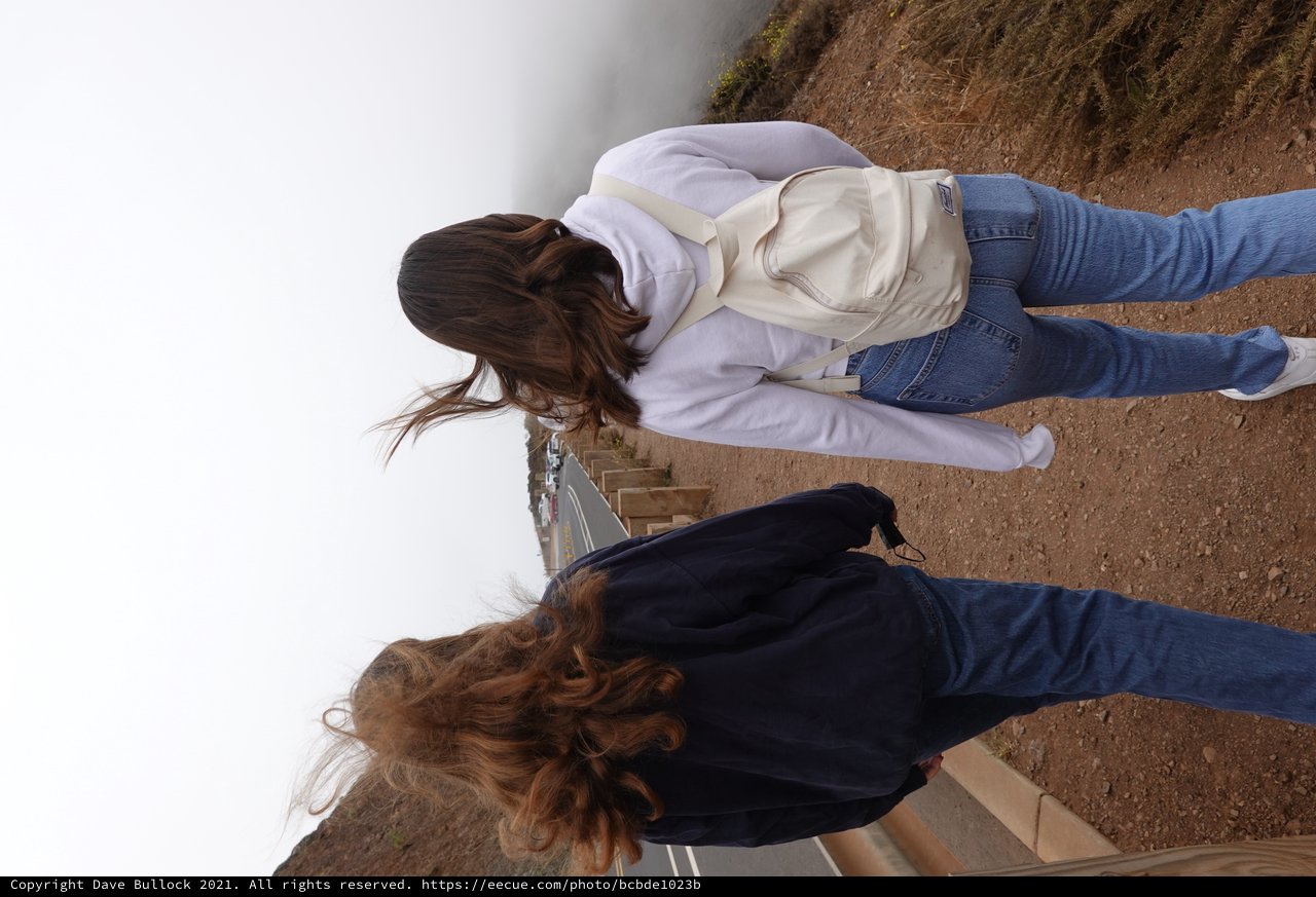 Two Women Walking in Strong Coastal Wind