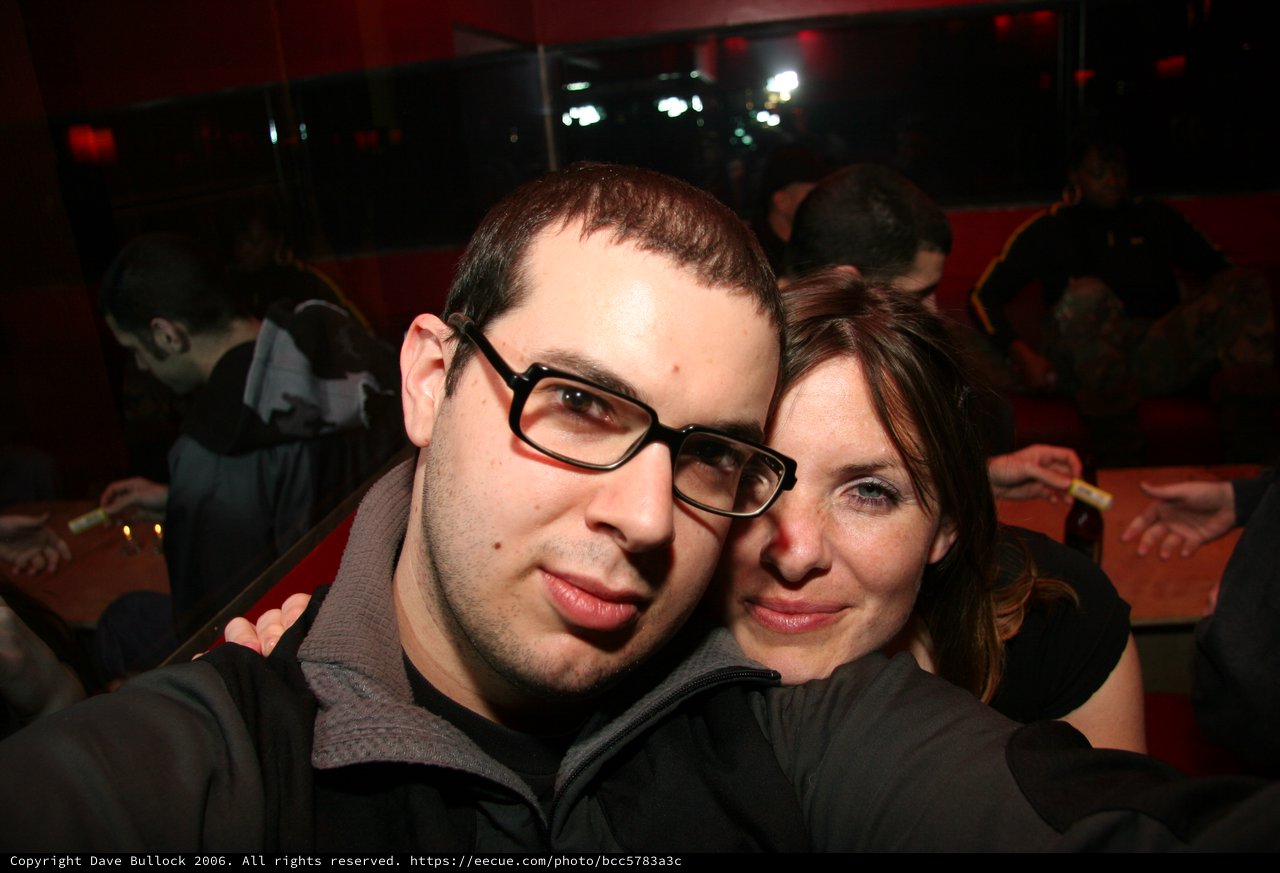 Couple Poses Together at Dimly Lit Nightclub