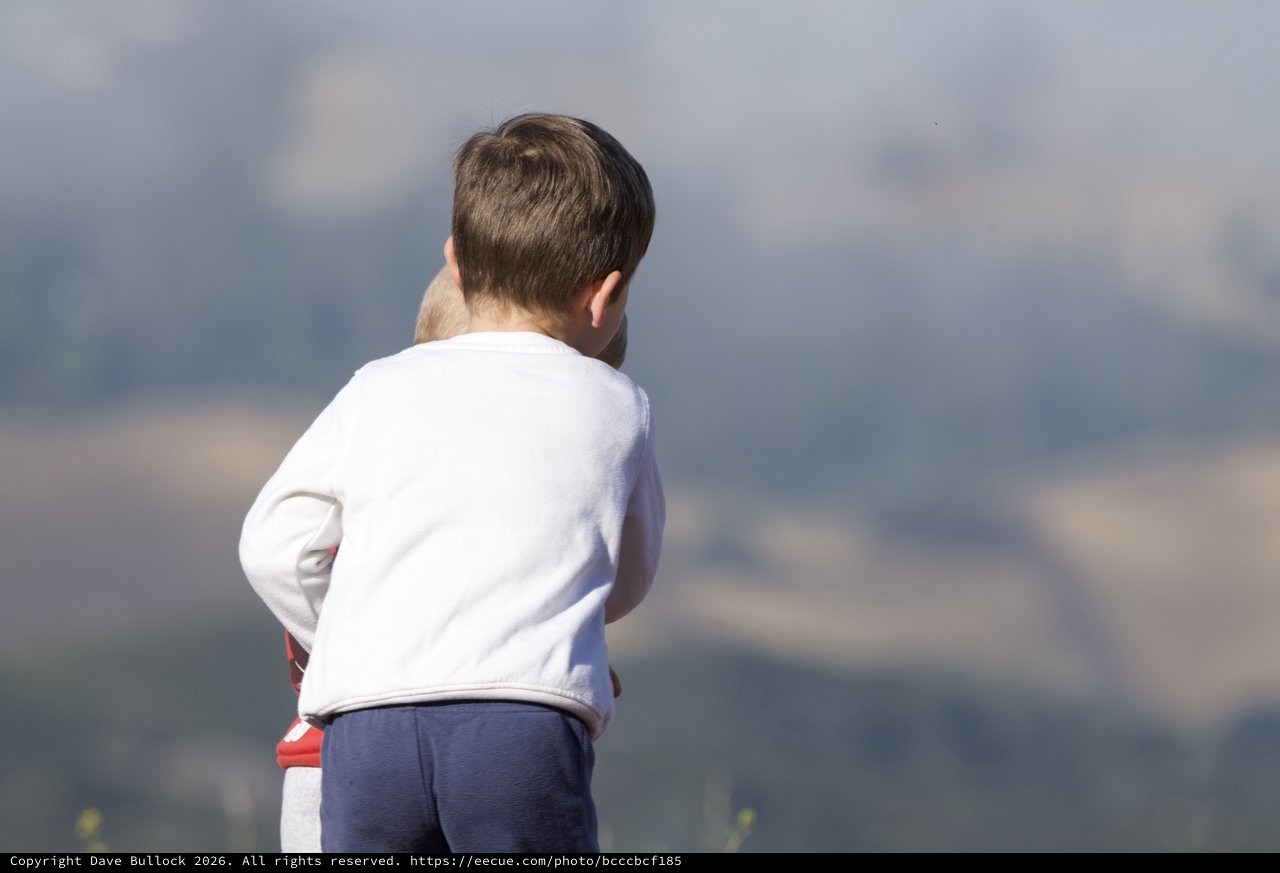 Young Child Gazing Out Over Mountain Vistas