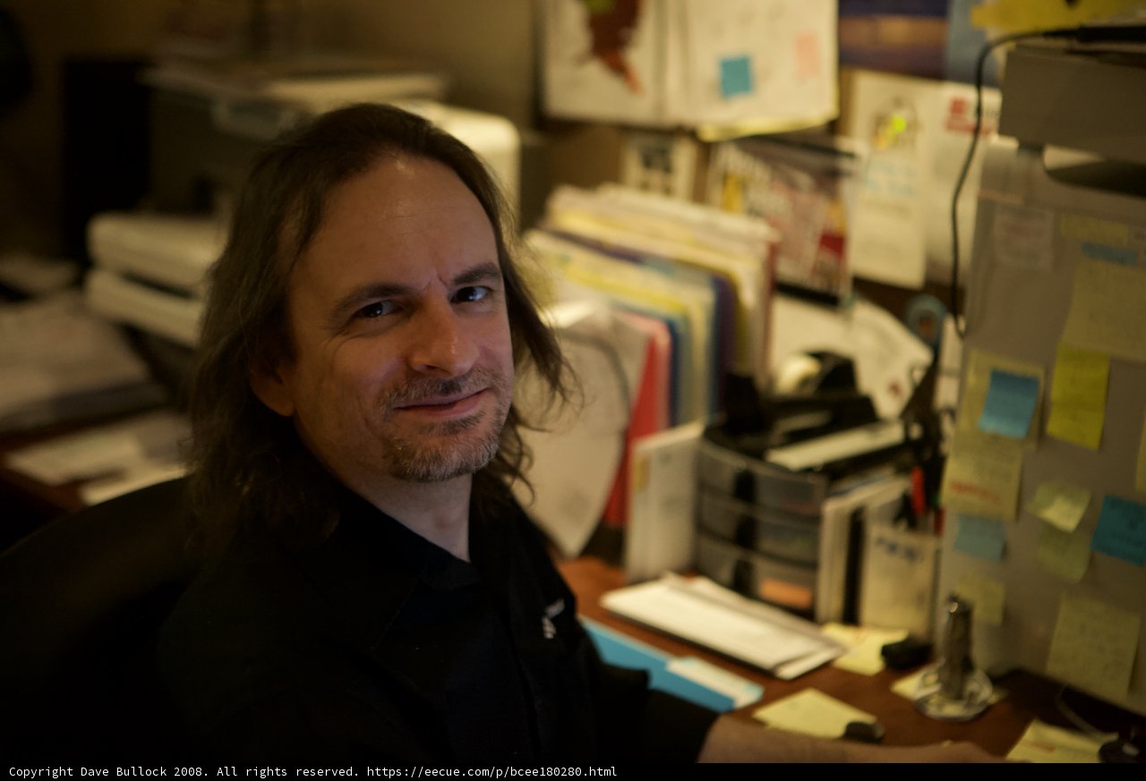 Long-Haired Man at his Workstation