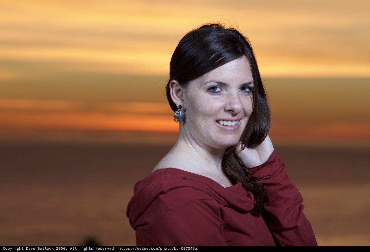 Woman Glowing Against a Vibrant Sunset Sky
