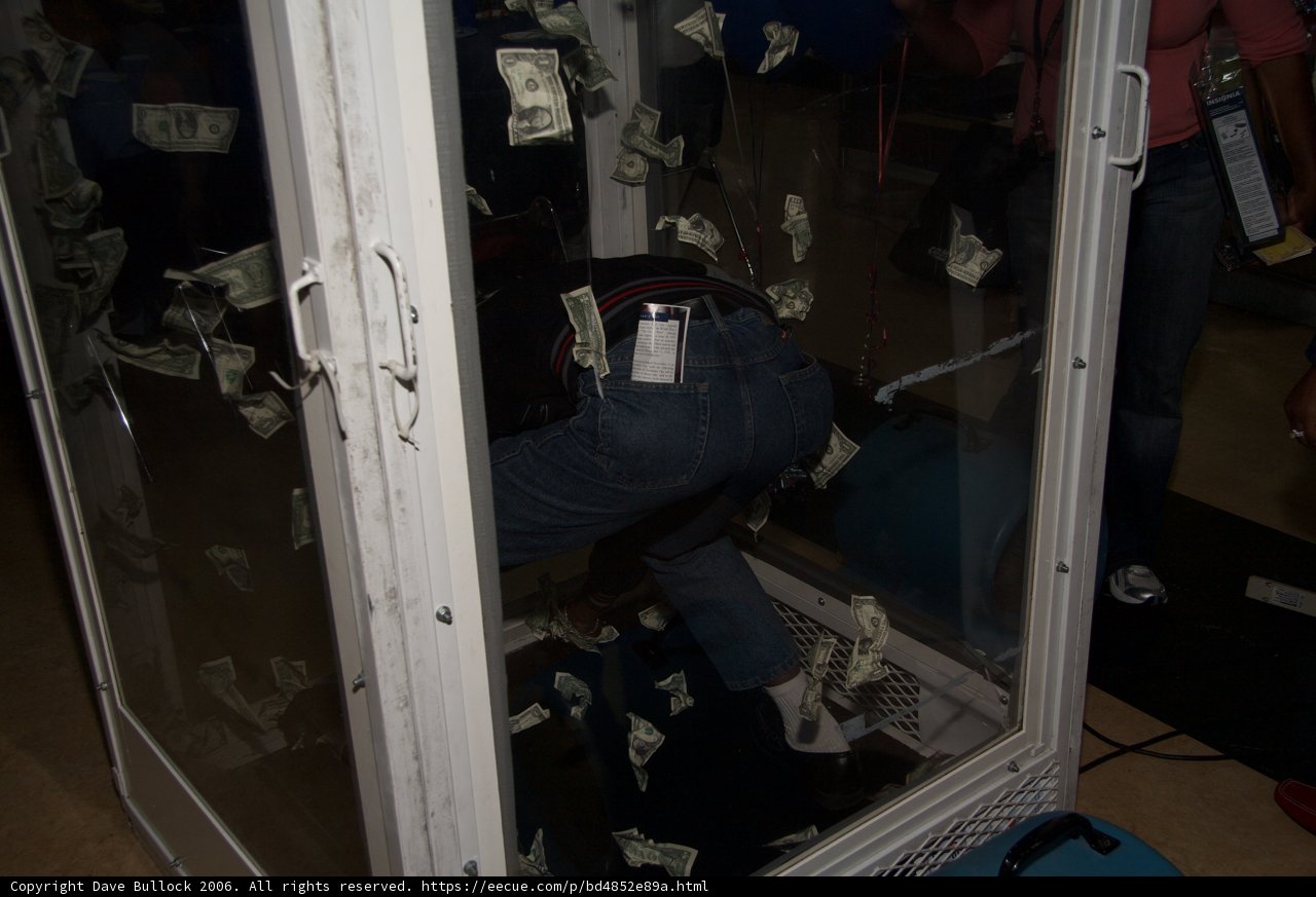 Man in Glass Case with Money