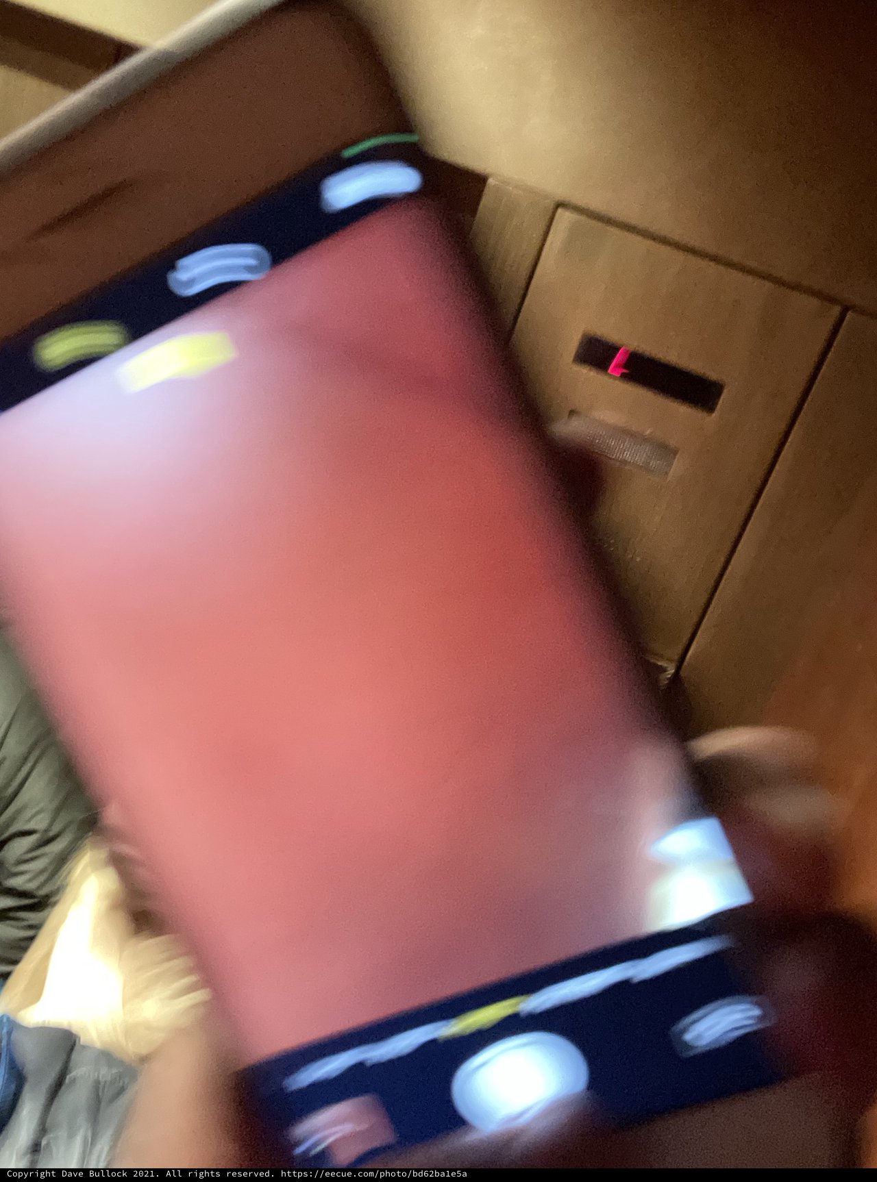 Motion-Blurred Pink Laptop Being Held in Bedroom