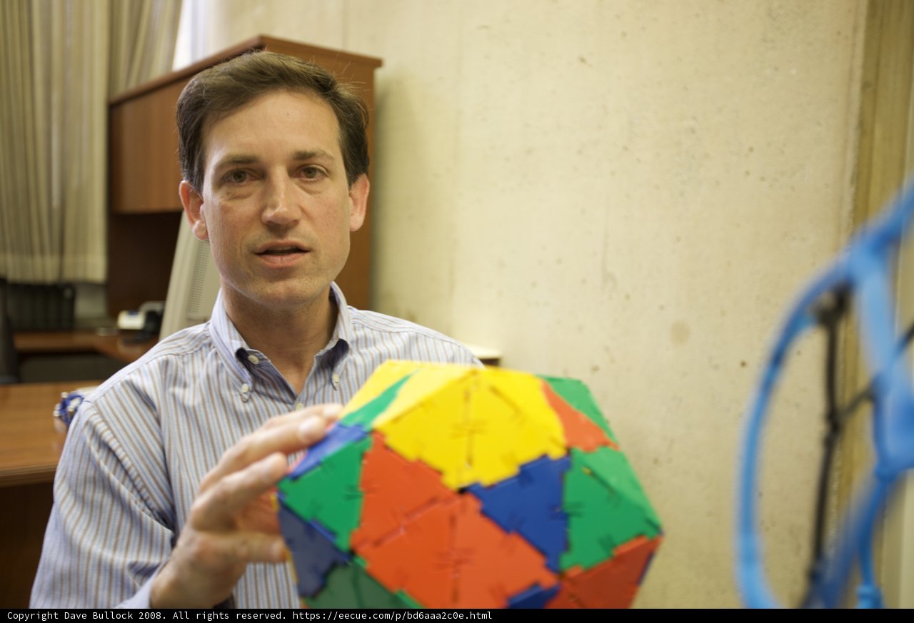 Colorful Sphere in the Hands of a Man