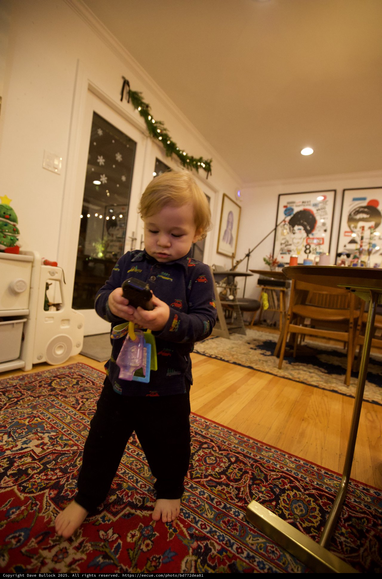 Toddler Examining Toy in Cozy Christmas Home
