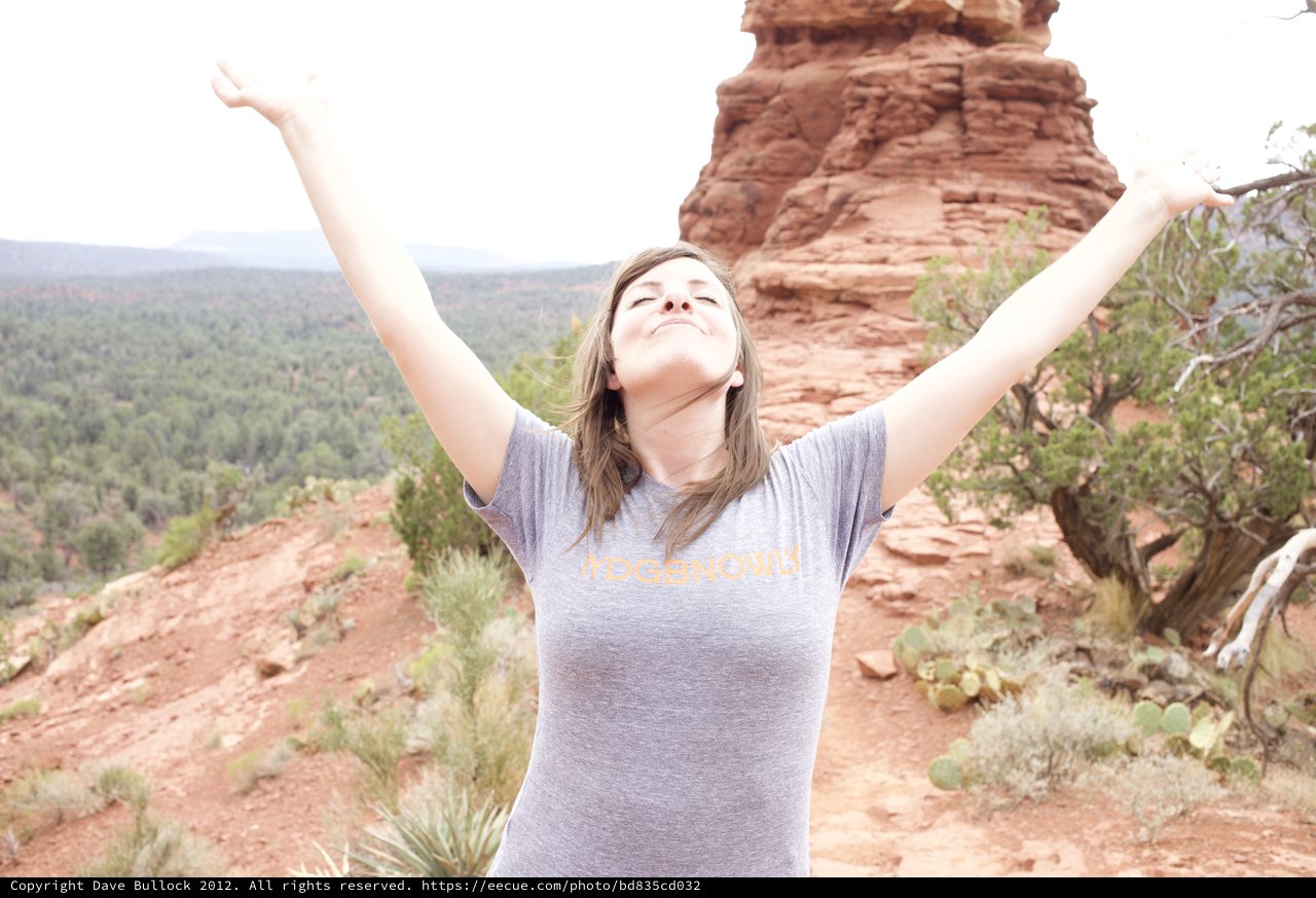Triumphant Woman Celebrates Atop Sedona Red Rocks