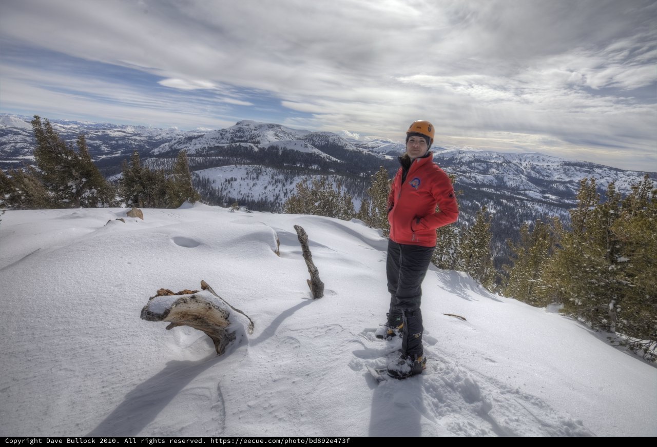 Summit Victory: Mountaineer Atop Snowy Sierra Peak
