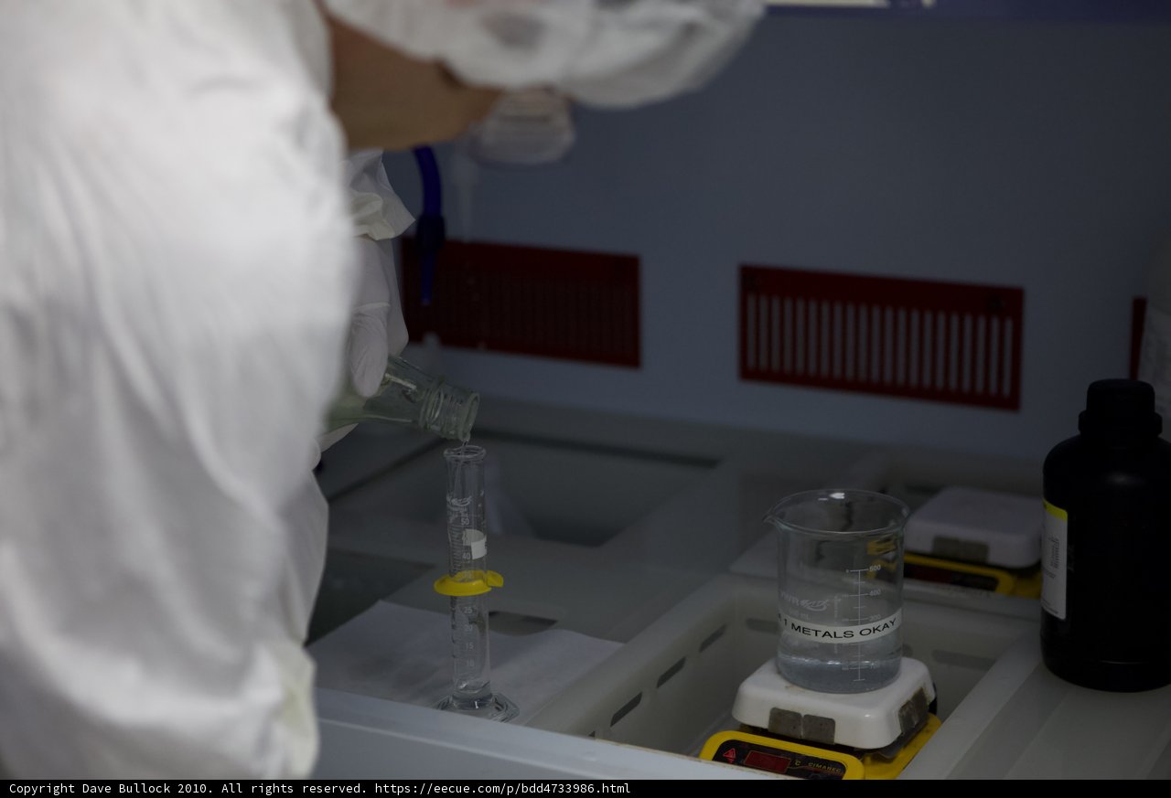 Man in Lab Coat Conducting Experiment