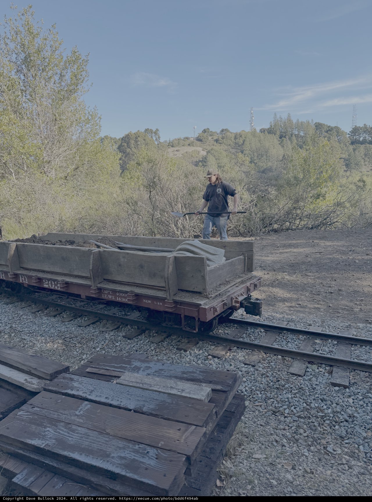 Railway Worker Repairing Historic Train Car