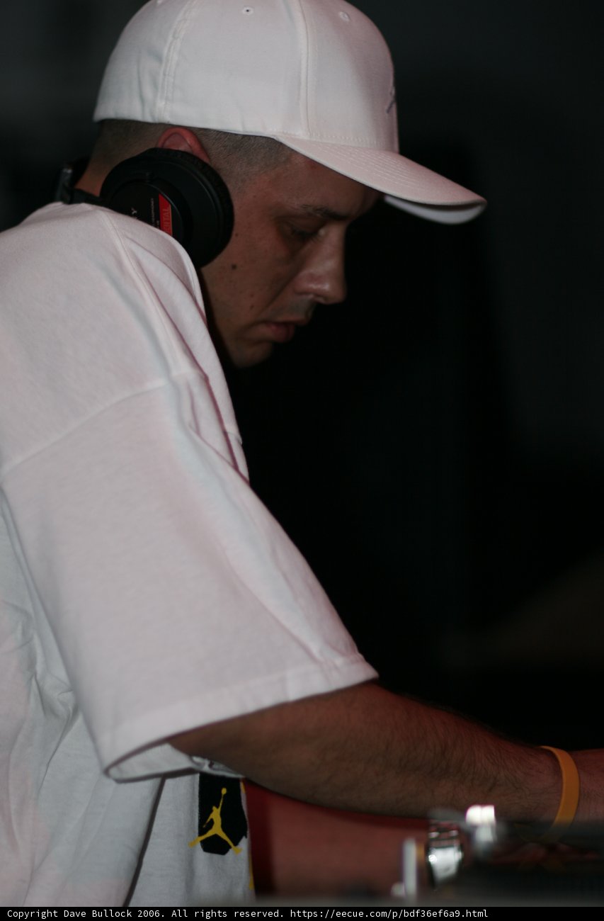 Dj S sporting a stylish white T-shirt and baseball cap