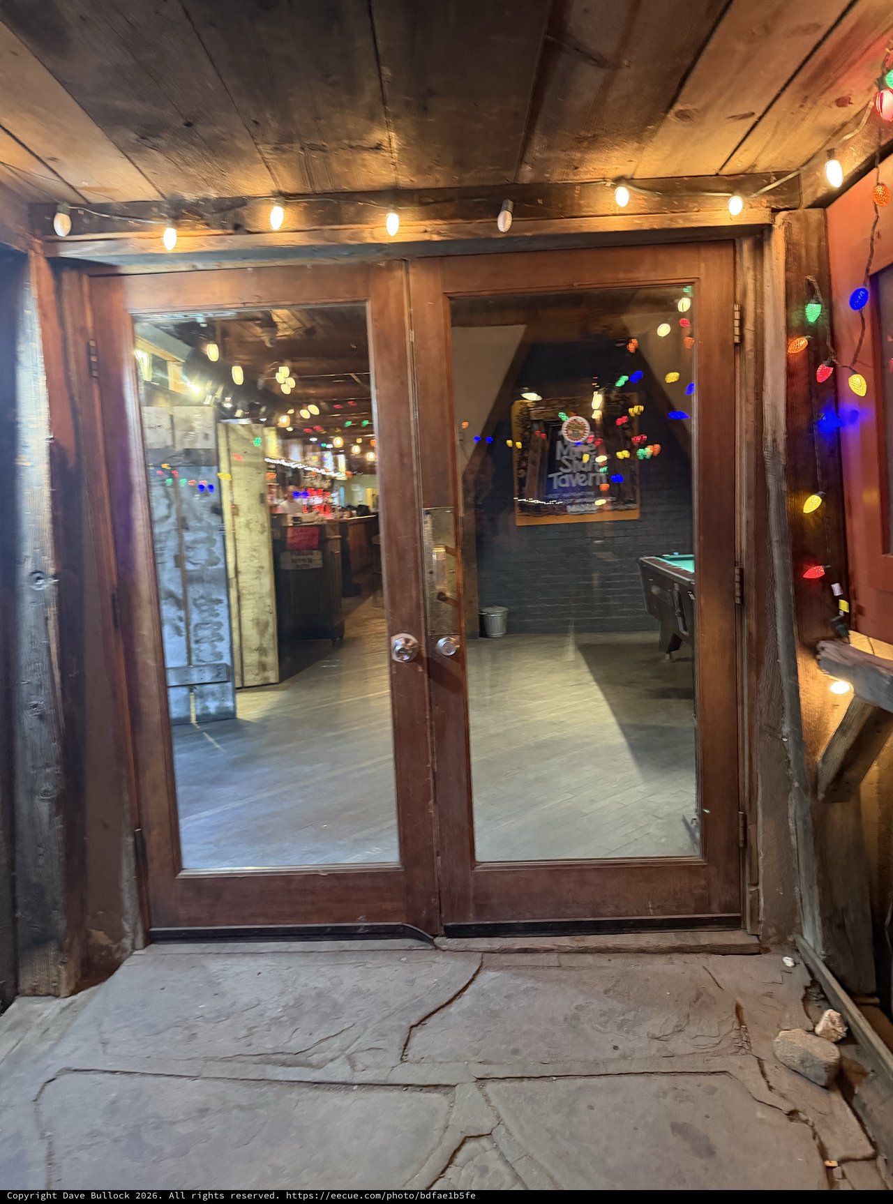 Rustic Tavern Entrance Decorated with Festive String Lights