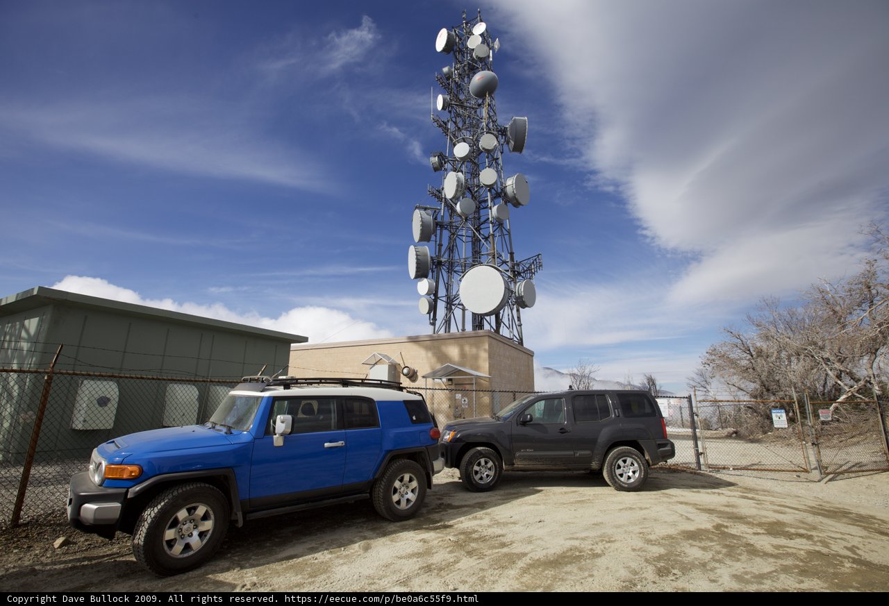Suvs Parked in Front of Cell Tower