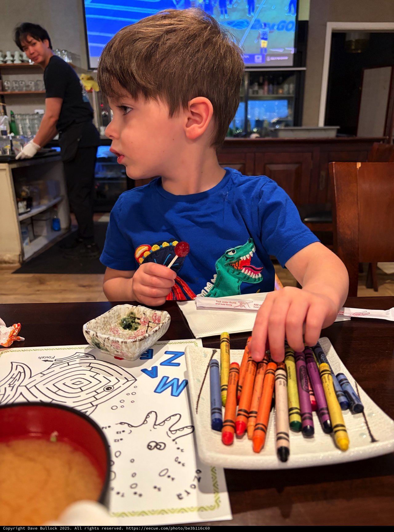 Young Boy Coloring with Crayons at Home